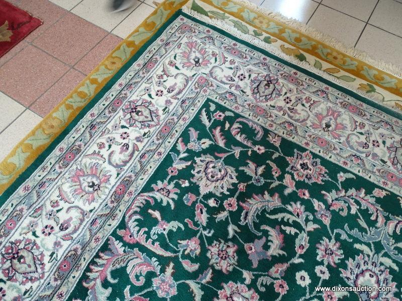 HANDMADE ORIENTAL BOKHARA IN GREEN, IVORY, AND MAUVE. MEASURES APPROXIMATELY 8 FT 11 IN X 12 FT.