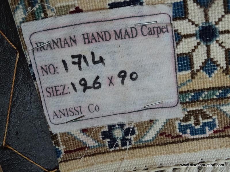 HANDMADE IRANIAN AREA RUG IN IVORY, BLUE, AND BROWN. MEASURES APPROXIMATELY 2 FT 11 IN X 4 FT 6 IN.