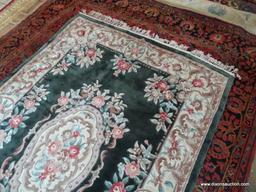 HANDMADE SCULPTED CHINESE RUG IN GREEN, IVORY, AND MAUVE. MEASURES APPROXIMATELY 4 FT 6 IN X 5 FT 7