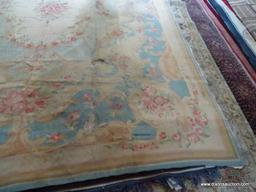 ESTATE OWNED VINTAGE HANDMADE TAPESTRY RUG. HAS SOME DAMAGE. IS BLUE, MAUVE AND IVORY IN COLOR.