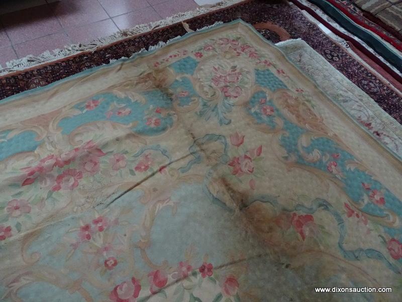 ESTATE OWNED VINTAGE HANDMADE TAPESTRY RUG. HAS SOME DAMAGE. IS BLUE, MAUVE AND IVORY IN COLOR.