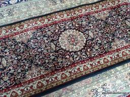 MACHINE MADE ISFAHAN IN BLACK, MAROON, AND IVORY. MEASURES 2 FT X 7 FT 7 IN. ITEM IS SOLD AS IS
