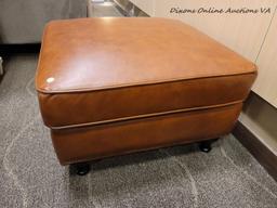 (R1) MODERN LEATHER UPHOLSTERED OTTOMAN IN BROWN WITH ESPRESSO FINISH LEGS. MEASURES 29 IN X 29 IN X