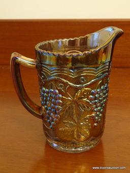 (DR) INTERNATIONAL GLASS CARNIVAL GLASS PITCHER IN THE GRAPE PATTERN- 6 IN H, ITEM IS SOLD AS IS