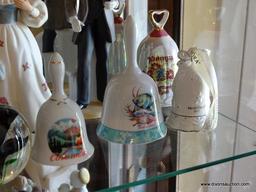 (FR) SHELF LOT IN CABINET TO INCLUDE: (5) DECORATIVE CERAMIC BELLS, (2) PORCELAIN FIGURINES OF A MAN
