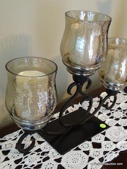 (FR) BLACK METAL DECORATIVE CANDELABRA WITH (3) AMBER COLORED GLASS SHADES & PIER 1 CANDLES.