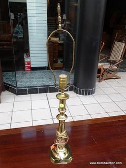 (R1) BRASS CANDLESTICK STYLE LAMP WITH HARP AND BRASS FINIAL. MEASURES 28 IN TALL. ITEM IS SOLD AS