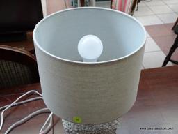 (R1) WHITE FLORAL PATTERN LAMP WITH CLOTH SHADE. MEASURES 14 IN TALL. ITEM IS SOLD AS IS WHERE IS