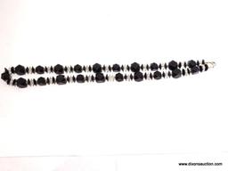 (SC) BLACK AND CLEAR PLASTIC COSTUME JEWELERY NECKLACE 24 IN LONG. ITEM IS SOLD AS IS, WHERE IS,