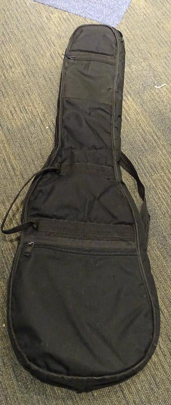 (SC) SOFT CASE GUITAR CARRYING BAG. HAS A SMALL HOLE IN THE BOTTOM OF THE CASE. ITEM IS SOLD AS IS