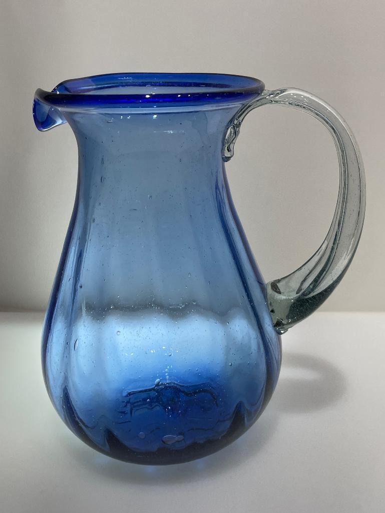 (2B) FOUR BLUE GLASS PITCHERS INCLUDING HAND BLOWN 9.5 INCH PITCHER (POSSIBLY NOVICA FIESTA);