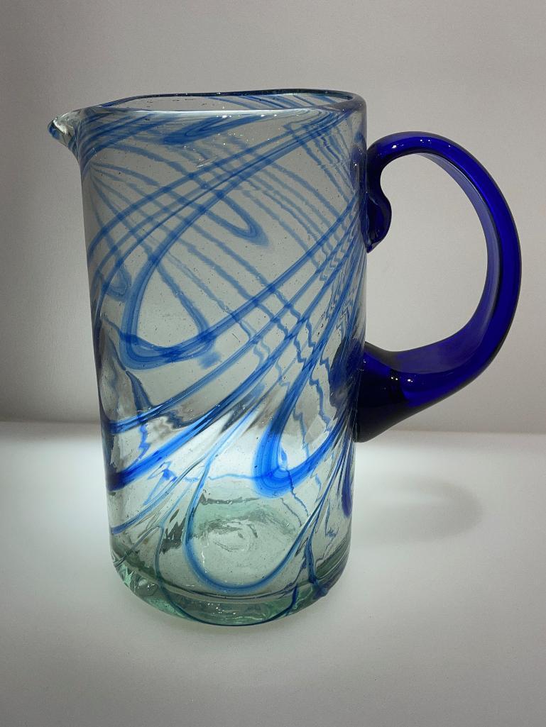 (2B) FOUR BLUE GLASS PITCHERS INCLUDING HAND BLOWN 9.5 INCH PITCHER (POSSIBLY NOVICA FIESTA);