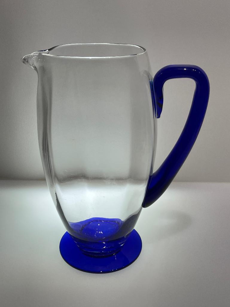 (2B) FOUR BLUE GLASS PITCHERS INCLUDING HAND BLOWN 9.5 INCH PITCHER (POSSIBLY NOVICA FIESTA);