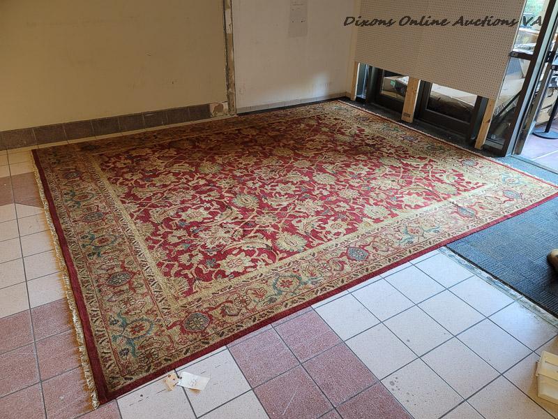 (DR) BRAND NEW HAND MADE "AGRA" AREA RUG IN HUES OF RED, GOLD, AND GREEN. ORIGINALLY RETAILED FOR