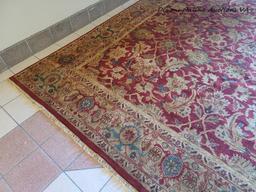 (DR) BRAND NEW HAND MADE "AGRA" AREA RUG IN HUES OF RED, GOLD, AND GREEN. ORIGINALLY RETAILED FOR