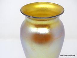Gold iridescent vase having a wide lip and shoulder tapering to a thin ankle above a round foot. 8