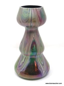 A translucent, gourd shaped green glass having surface decoration of opaque white and purple swirls.