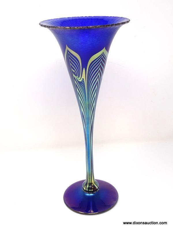 Cobalt Blue, iridescent finished trumpet vase having with a stretched finish. The tapering body and