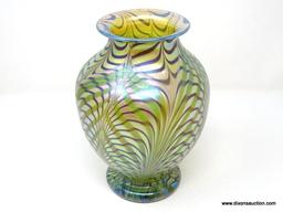 Gold translucent glass with brown feathered waves over green pulled & feathered decoration. The lip