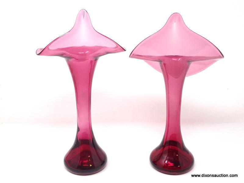 A pair of translucent cranberry glass Jack-in-the-Pulpit shaped vases. No signature found.