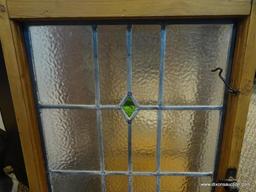 (WIN) FRAMED STAINED GLASS WINDOW HANGER. MEASURES 19 IN X 31.5 IN. ITEM IS SOLD AS IS WHERE IS WITH