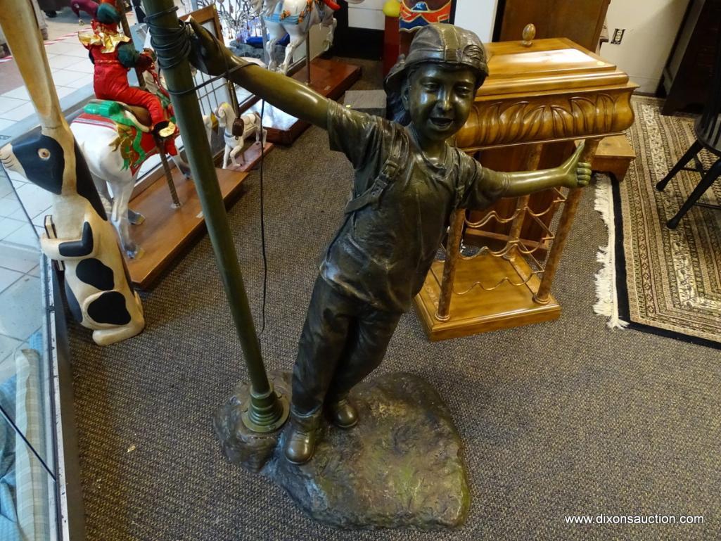 (WIN) BRONZE BOY LAMP POST STATUE. MEASURES APPROXIMATELY 44 IN X 88 IN. SIMILAR ITEMS RETAIL FOR