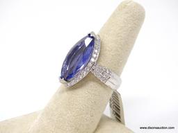 PLATINUM LADIES CAST TANZANITE AND DIAMOND RING.