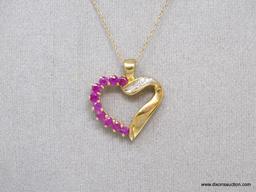 10K YELLOW GOLD RUBY AND DIAMOND HEART PENDANT ON 10K YELLOW GOLD CHAIN. THE PENDANT FEATURES 10