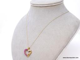 10K YELLOW GOLD RUBY AND DIAMOND HEART PENDANT ON 10K YELLOW GOLD CHAIN. THE PENDANT FEATURES 10