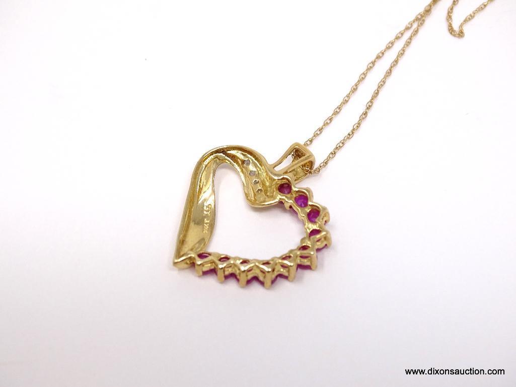 10K YELLOW GOLD RUBY AND DIAMOND HEART PENDANT ON 10K YELLOW GOLD CHAIN. THE PENDANT FEATURES 10