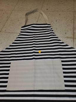 WHITE AND BLACK STRIPED APRON. PLEASE SEE THE PICTURES FOR MORE INFORMATION.
