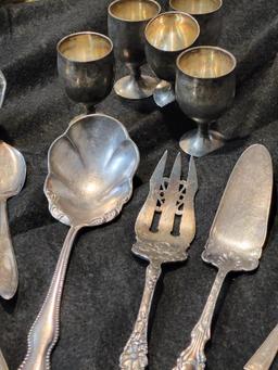 OVER 50 PIECE SILVERPLATE LOT. INCLUDES LADLES, SPOONS, FORKS, COASTERS AND MUCH MORE. IS SOLD AS IS