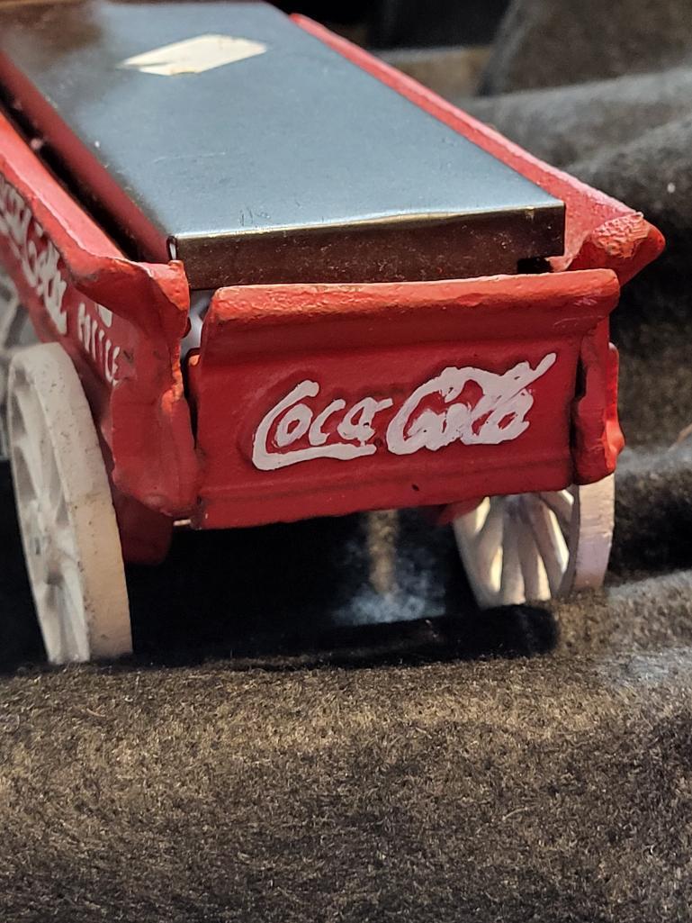 VINTAGE COCA COLA CAST IRON HORSE & DRAWN WAGON. ALSO, COMES WITH COCA COLA FANNY PACK. IS SOLD AS