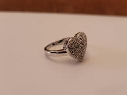 (DR) MARKED "925" STERLING SILVER HEART SHAPED RING, ACCENTED WITH SM. CZ CHIPS. IT WEIGHS APPROX.