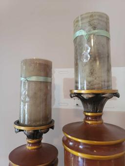 (LR) LOT OF 2 CANDLESTICK HOLDERS. DIFFERENT SIZES BUT BOTH HAVE A WOOD LOOK WITH PAINTED DETAILING.