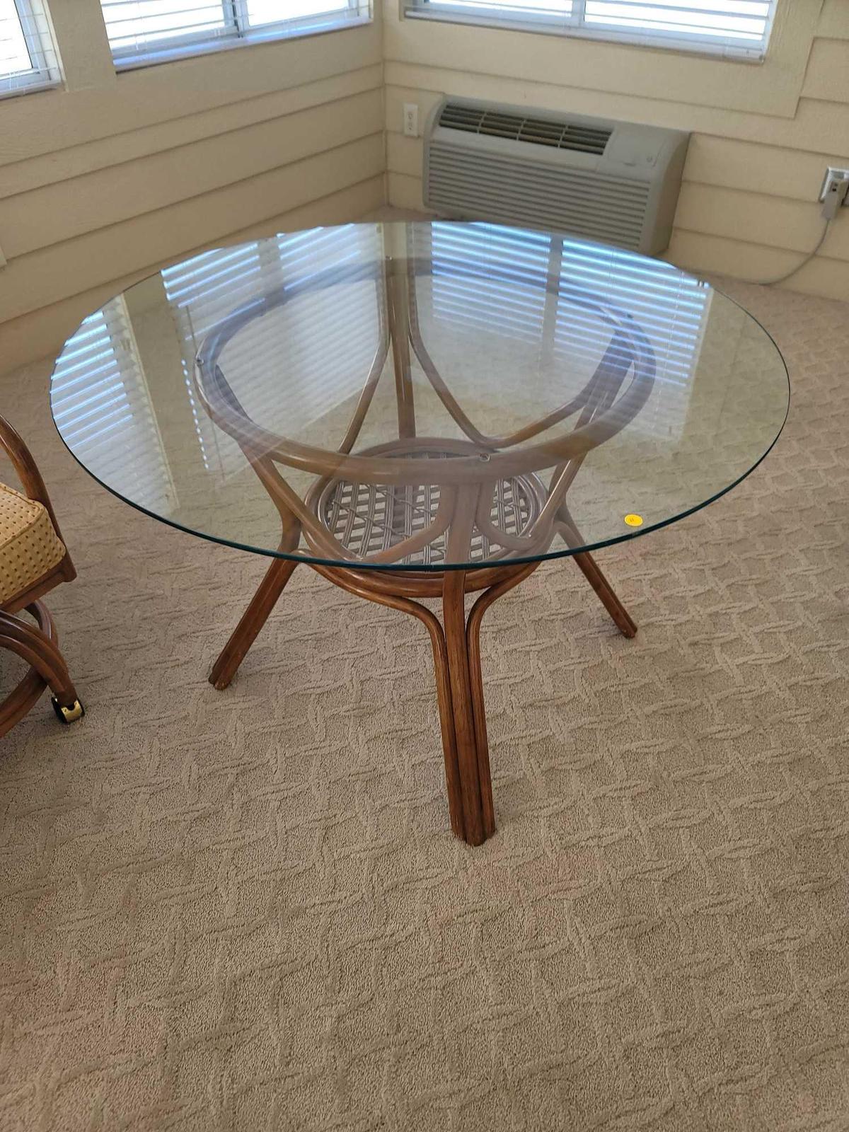 (SUNRM) GLASS TOP WOODEN TABLE WITH WOVEN STRETCHER CENTER. MEASURES APPROX. 47" DIAMETER X 27.5"