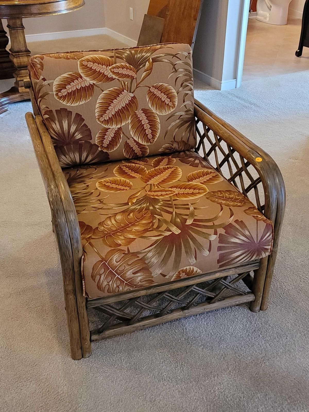 (LR) VINTAGE RATTAN ARM CHAIR WITH TROPICAL LEAF UPHOLSTERY & WOVEN RATTAN SIDES & BACK. IT MEASURES