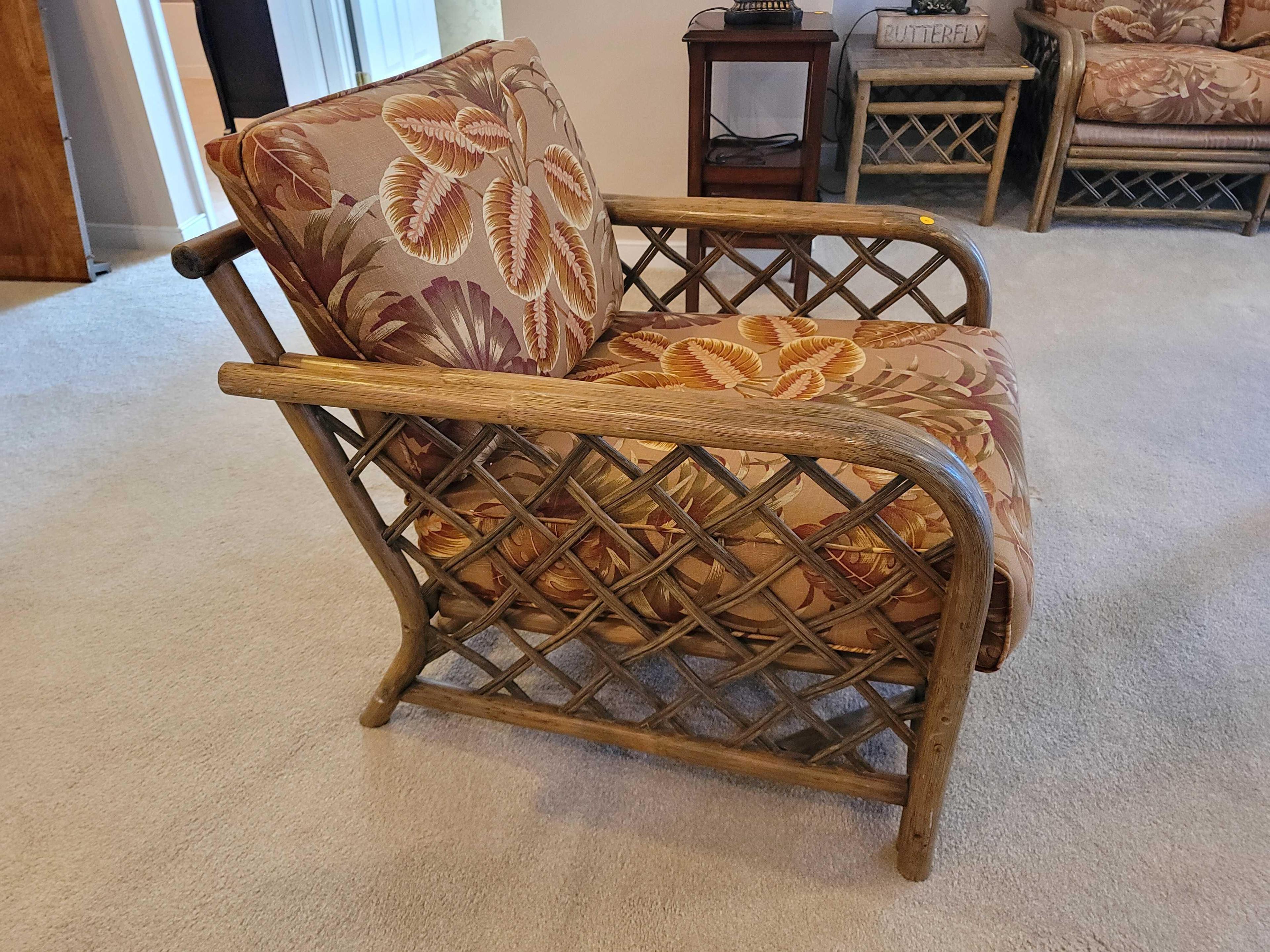 (LR) VINTAGE RATTAN ARM CHAIR WITH TROPICAL LEAF UPHOLSTERY & WOVEN RATTAN SIDES & BACK. IT MEASURES