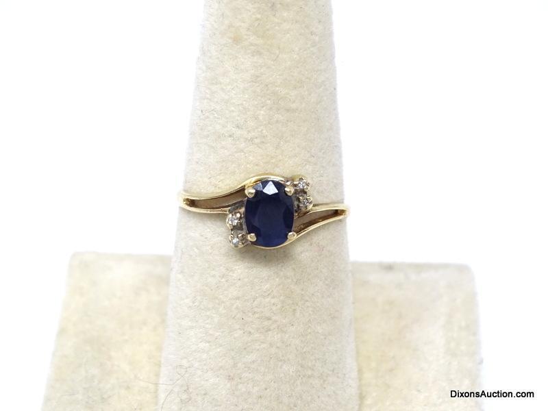 10K YELLOW GOLD BLUE SAPPHIRE & DIAMOND CHIP RING. OVAL CUT PRONG SET SAPPHIRE GEMSTONE WITH 2 SMALL