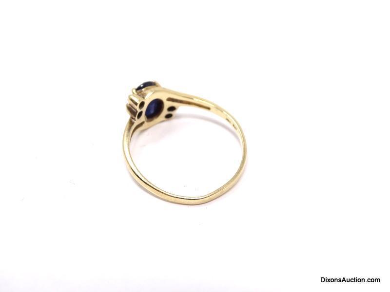 10K YELLOW GOLD BLUE SAPPHIRE & DIAMOND CHIP RING. OVAL CUT PRONG SET SAPPHIRE GEMSTONE WITH 2 SMALL