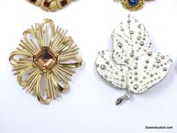 LOT OF (7) VINTAGE DECORATIVE BROOCHES TO INCLUDE A GOLD TONE LEAF/GREEN STONE BROOCH 2-1/2"L,