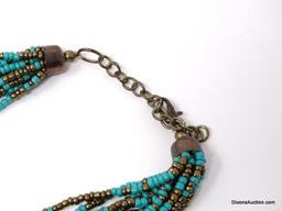 12 STRAND TURQUOISE AND BRONZE COLORED SEED BEAD NECKLACE WITH BRONZE TONED CAPS & LOBSTER CLASP. IT