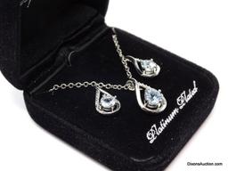 PLATINUM PLATED & PALE BLUE TOPAZ 3 PC. NECKLACE & EARRING SET. THE PENDANT HAS A SINGLE CENTER