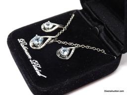 PLATINUM PLATED & PALE BLUE TOPAZ 3 PC. NECKLACE & EARRING SET. THE PENDANT HAS A SINGLE CENTER