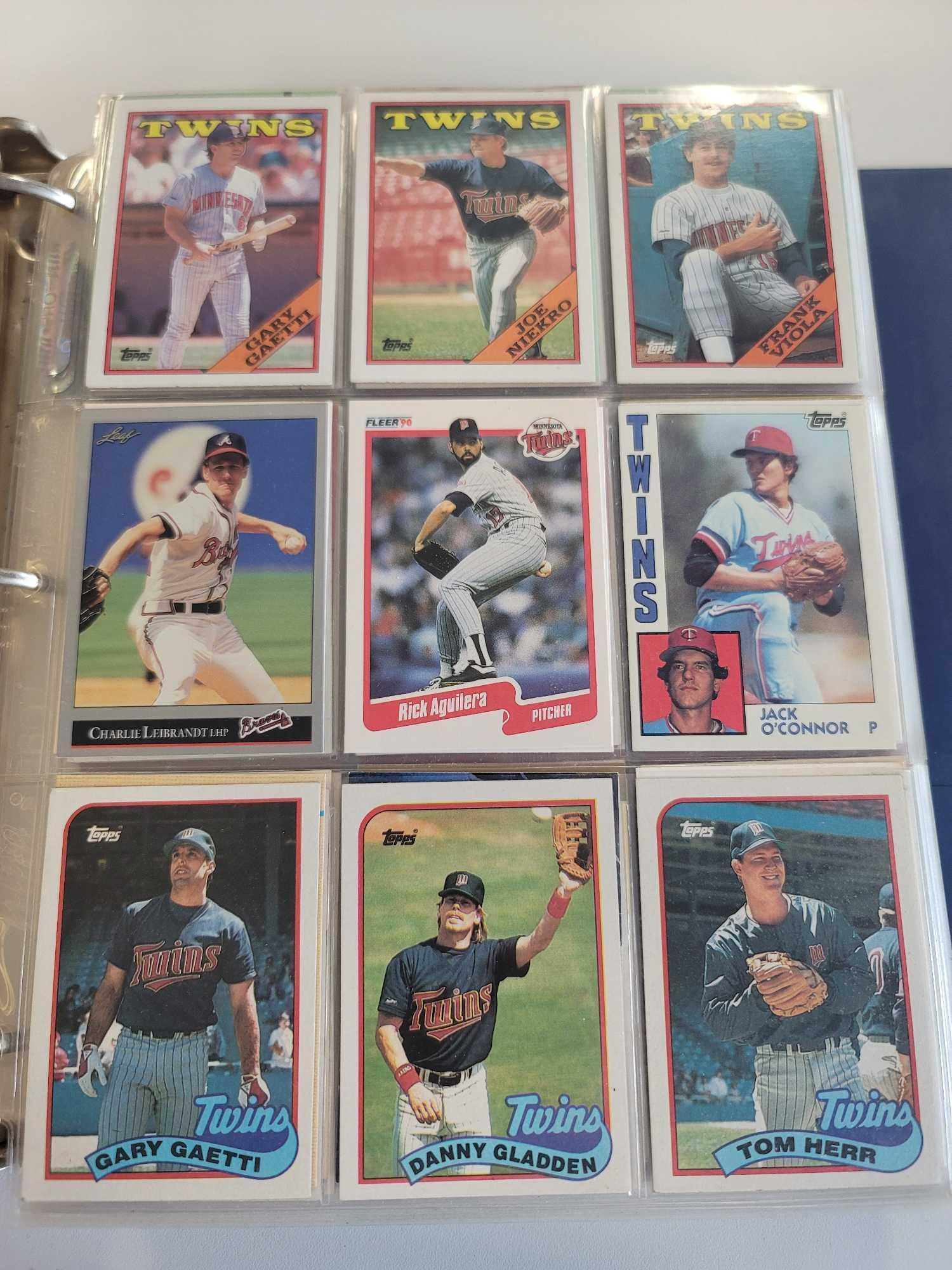 BLUE BINDER FULL OF ASSORTED MINNESOTA TWINS BASEBALL CARDS. ALL FROM THE 1980'S AND 1990'S. OVER 40