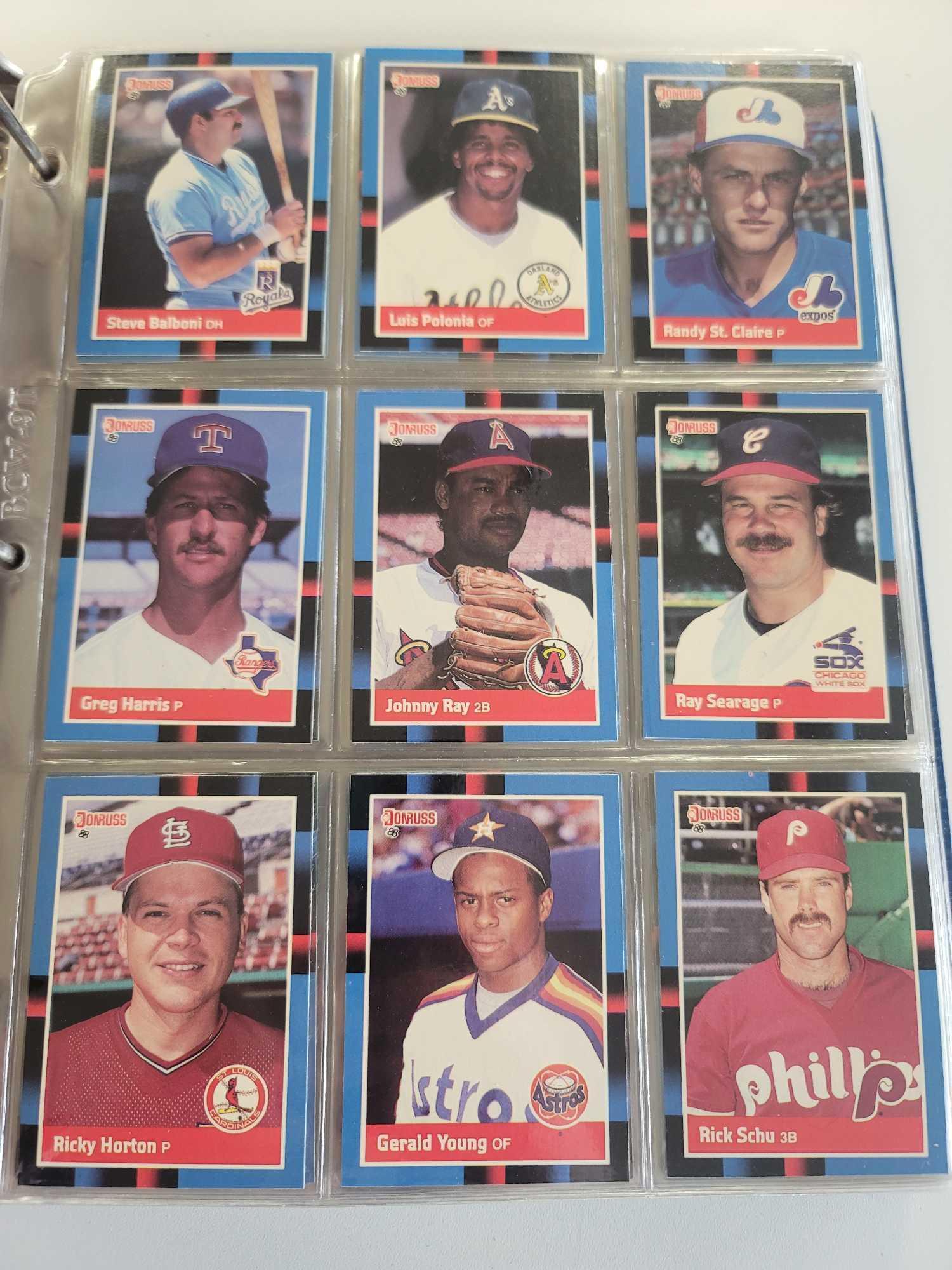 BLUE BASEBALL CARD ALBUM BINDER FILLED WITH ASSORTED BASEBALL CARDS. 658 IN TOTAL. TIM RAINES, MARK