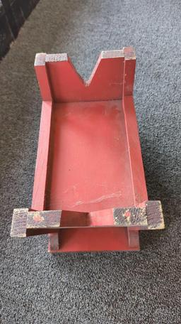 EARLY STYLE FIRE RED WOODEN STOOL WITH A SMALL UNDER SHELF MEASURES APPROXIMATELY 12 IN X 7 IN X 9