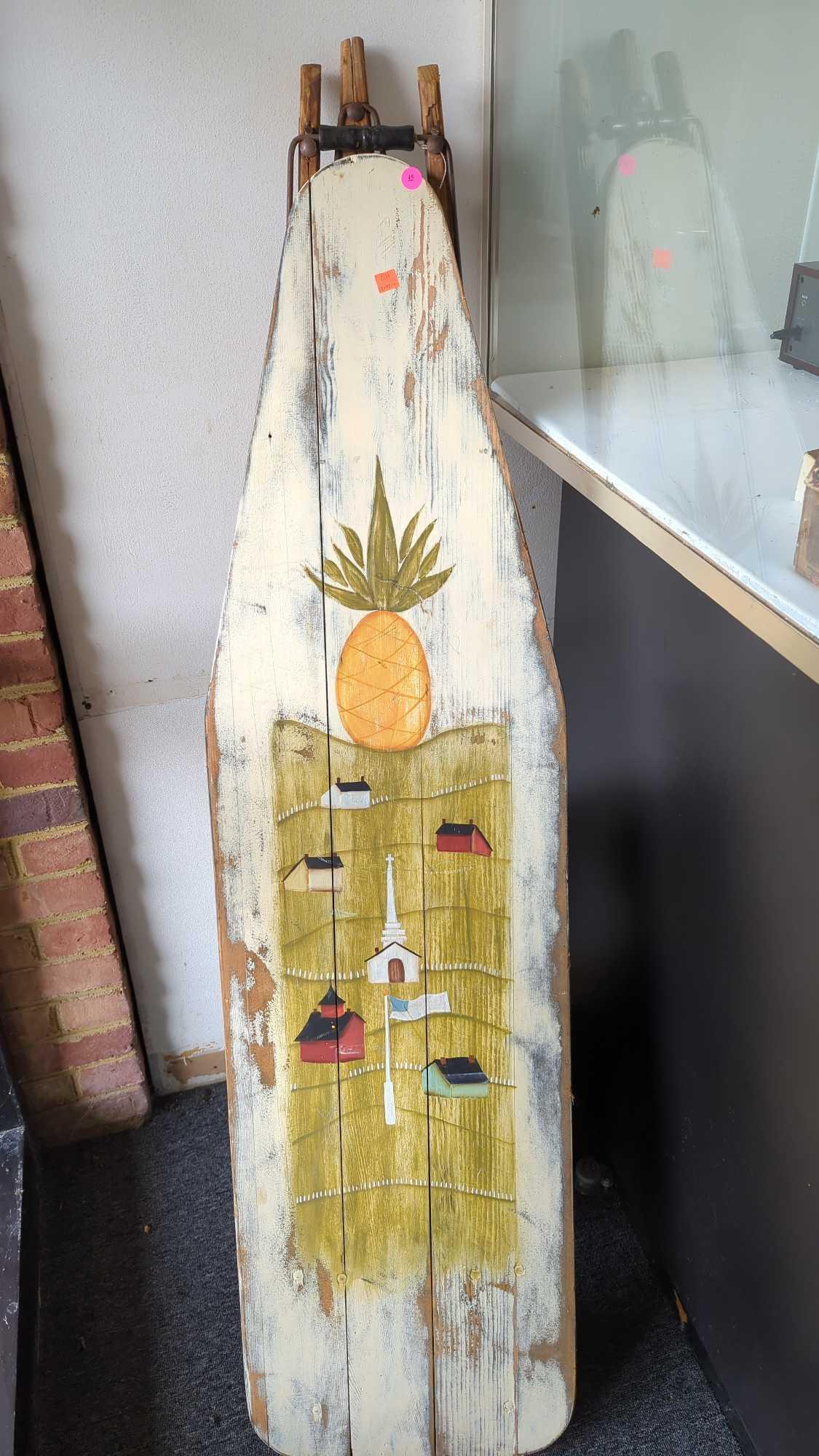 EARLY STYLE WOODEN IRONING BOARD DECORATION, ITEM HAS A PINEAPPLE AND HILLSIDE SCENE PAINTED ON THE