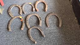 LOT OF ASSORTED EARLY STYLE HORSE SHOES AND HORSE BITS