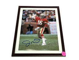 FRAMED & AUTOGRAPHED PHOTO OF JOE MONTANA. DISPLAYED IN A BROWN FRAME. IT MEASURES APPROX. 9-1/2" X